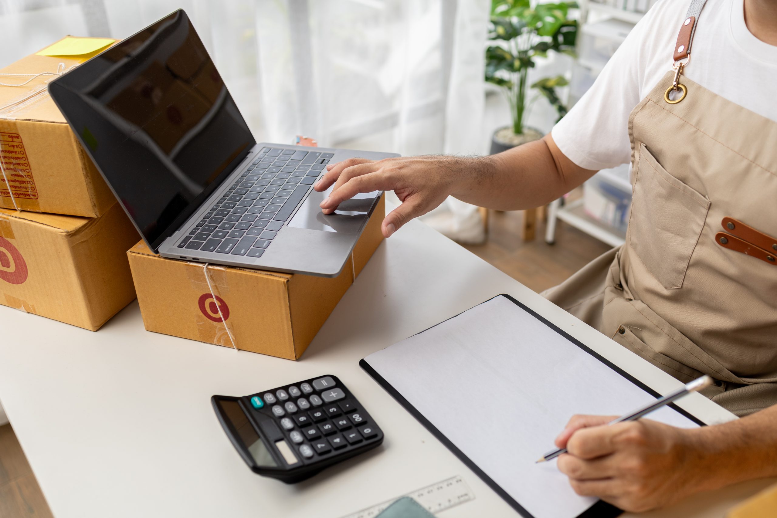 Online shop owner man, he checks orders on website, online shop